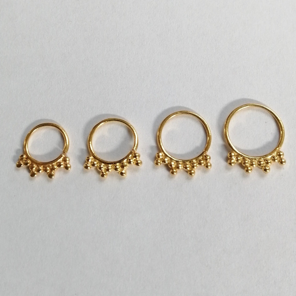 small gold piercing rings with ornaments