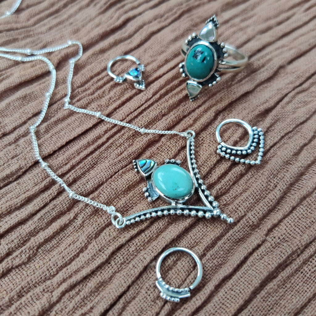 jewelry flatlay silver, abalone shell and turquoise