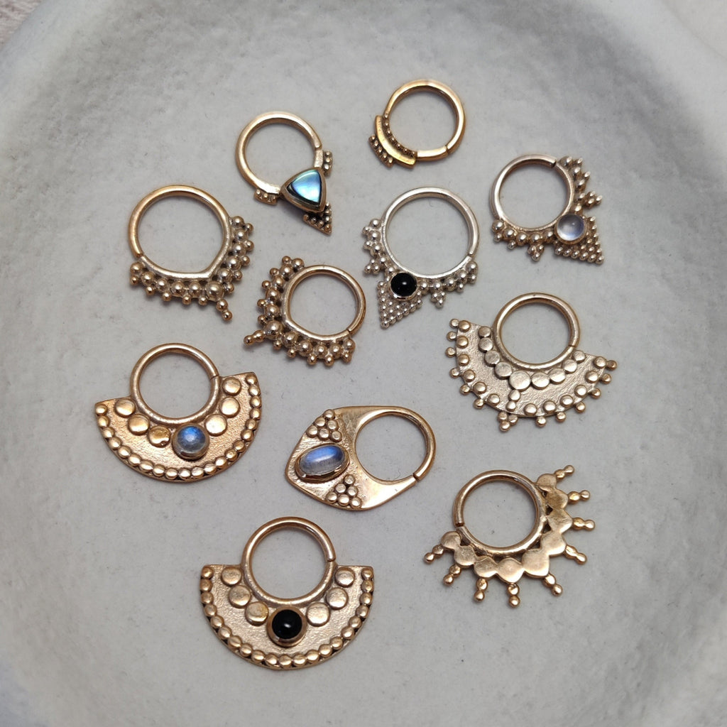 Solid gold septum collection, displayed on a jewelry plate. Noomaad design.