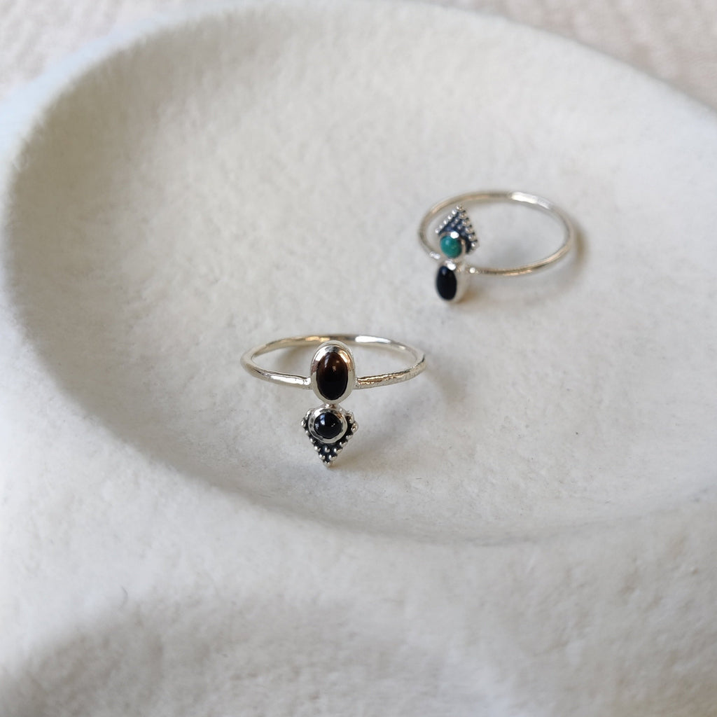 dainty silver rings with gemstones, front angle and side angle.