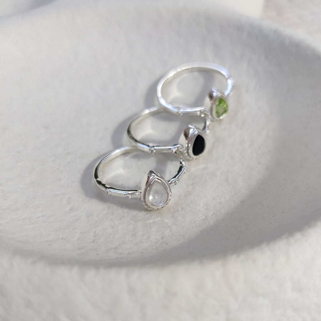 Bohemian silver ring with gemstones on a white surface.