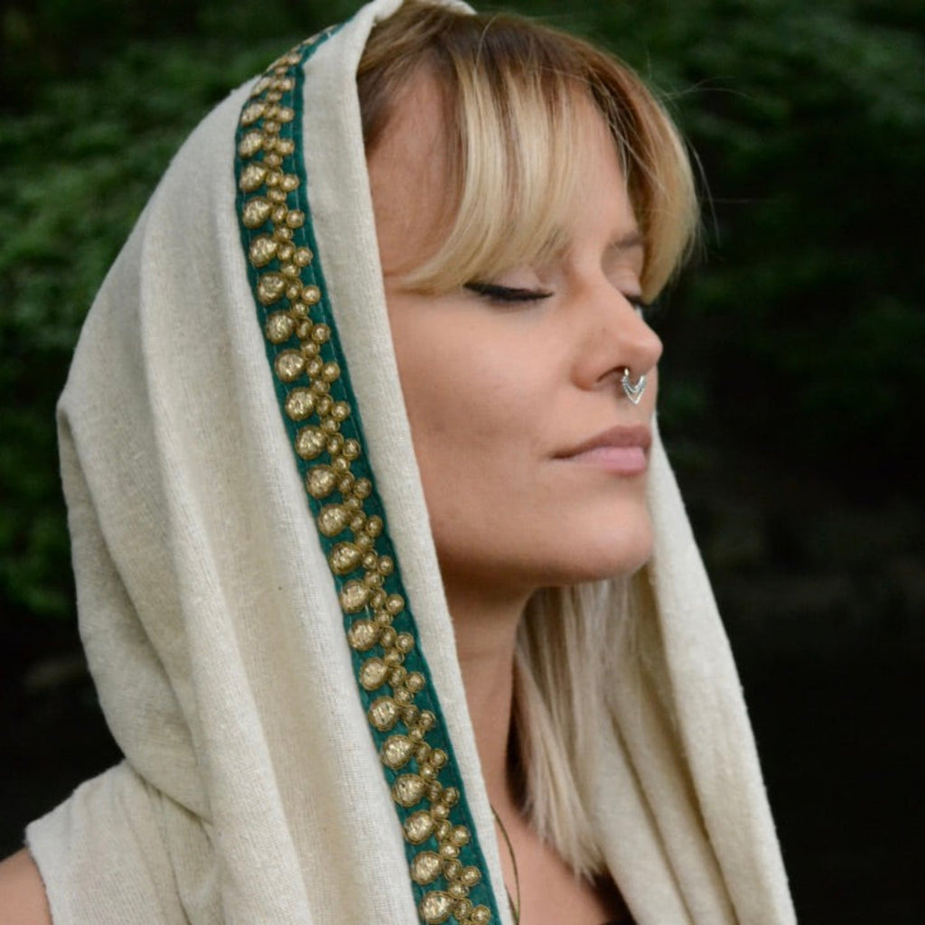 A model wearing a silver septum nose ring in a layered look, captured from the side to highlight the intricate design and elegant stacking effect.