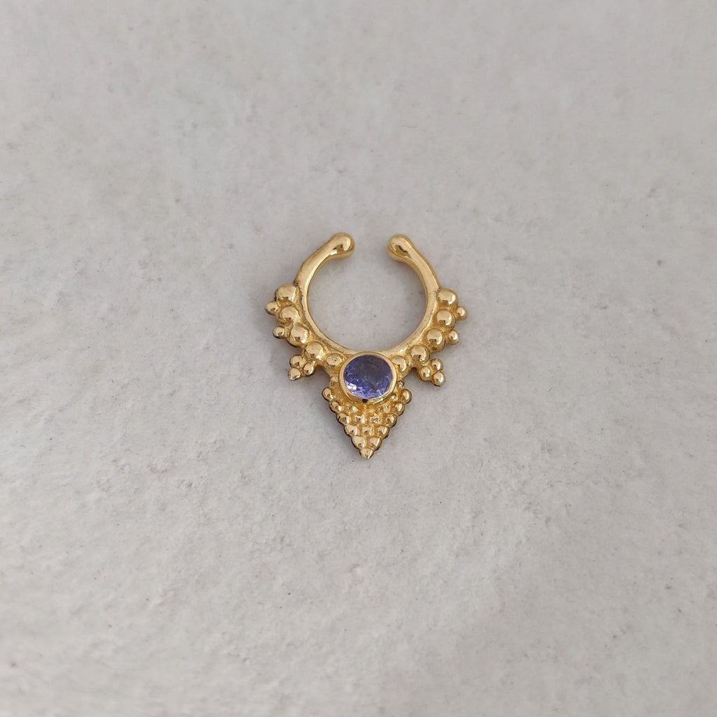 Triangle-shaped fake septum on gold with faceted tanzanite gemstone