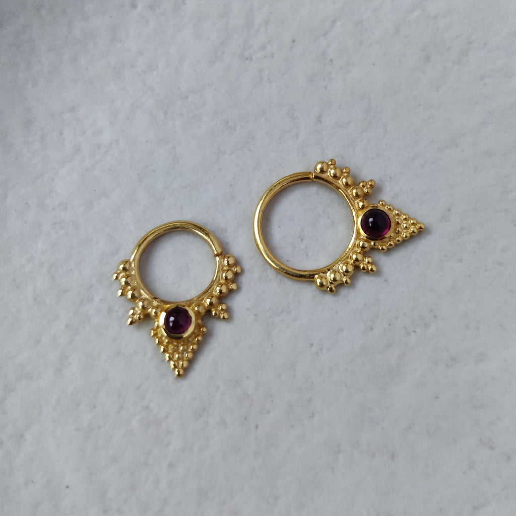 gold septum with garnet