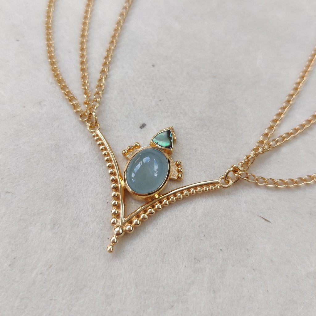 Gold head chain with blue prehnite and abalone shell. The design is v-shaped, with three chains draping from each side.