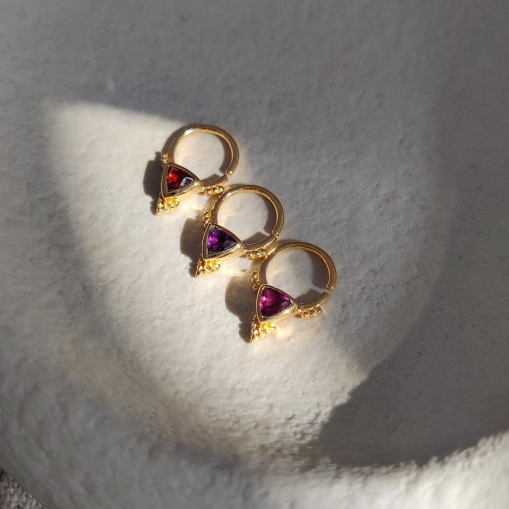 Three gold septum nose rings with various gemstones. Garnet, Amethyst and Rhodolite garnet