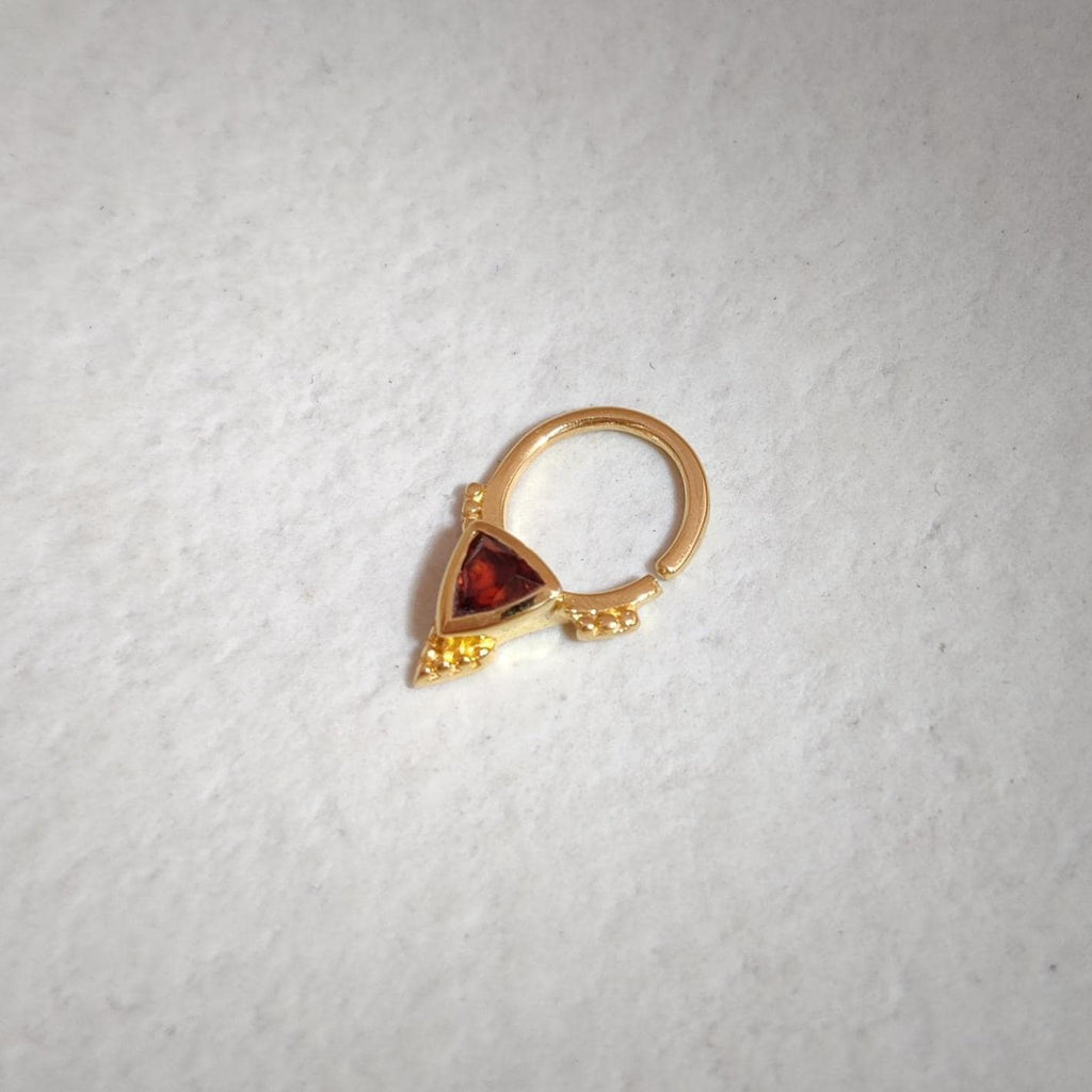 Gold septum with a triangle-shaped red gemstone