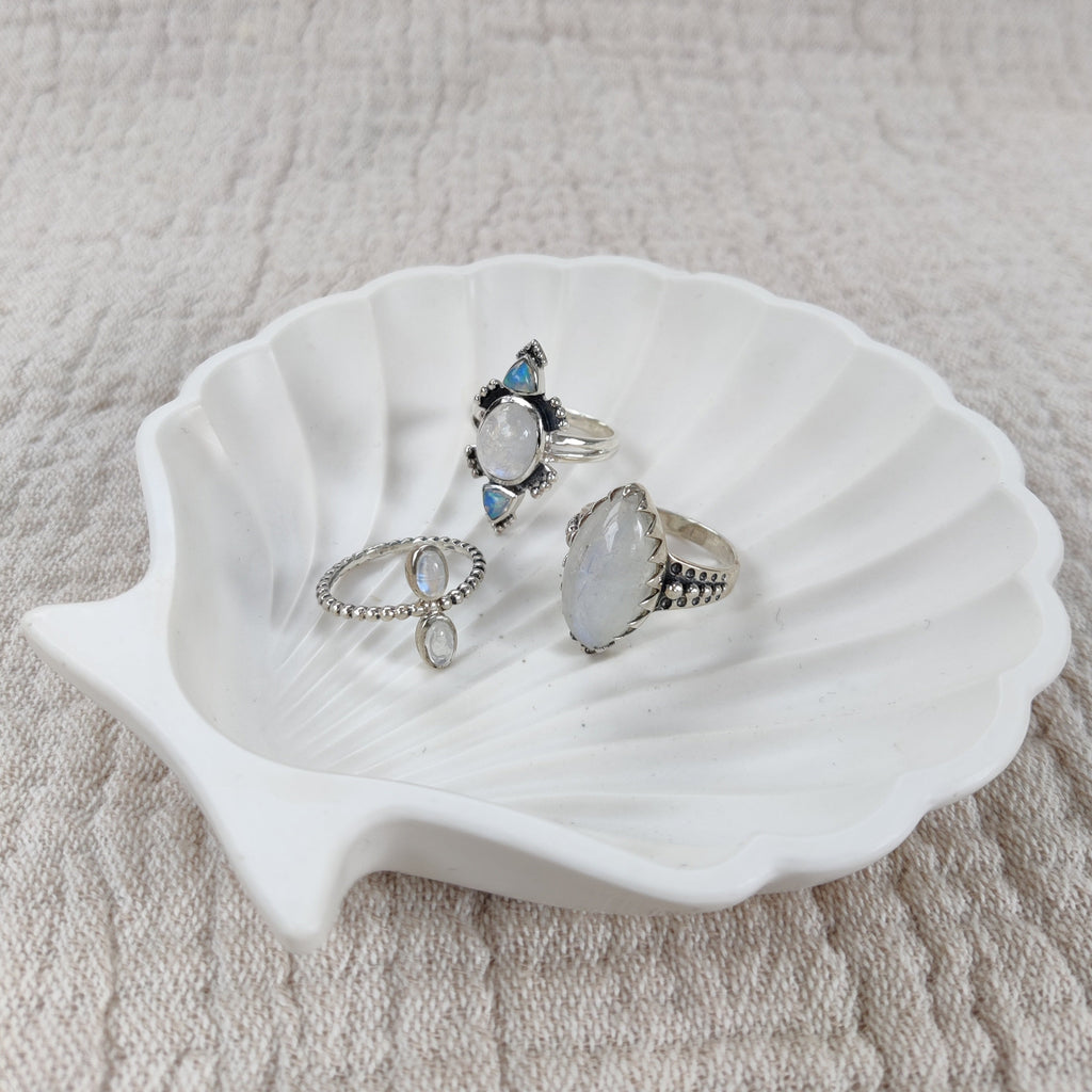 three moonstone rings on jewelry dish