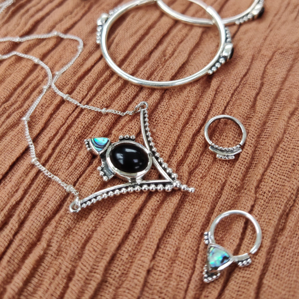 black onyx necklace, septum jewelry and hoop earrings