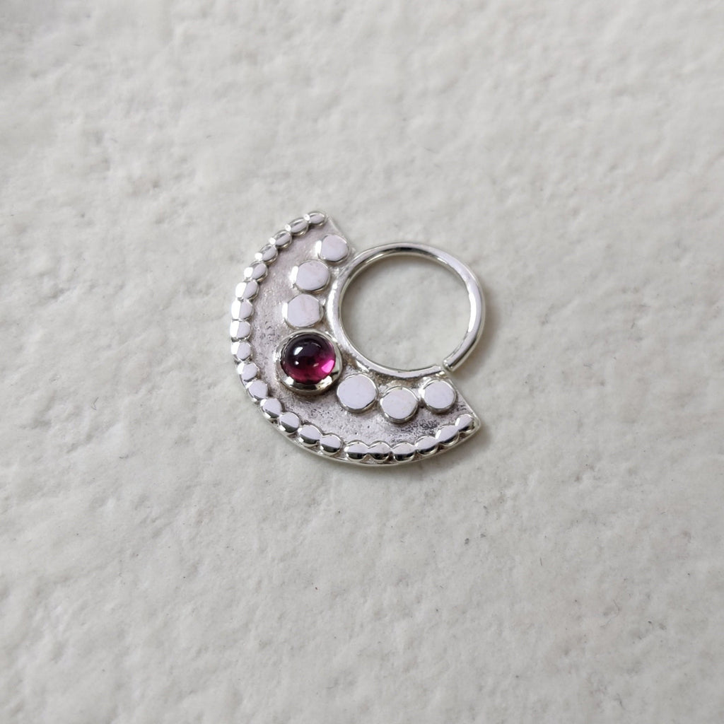 Silver septum nose ring with garnet. 