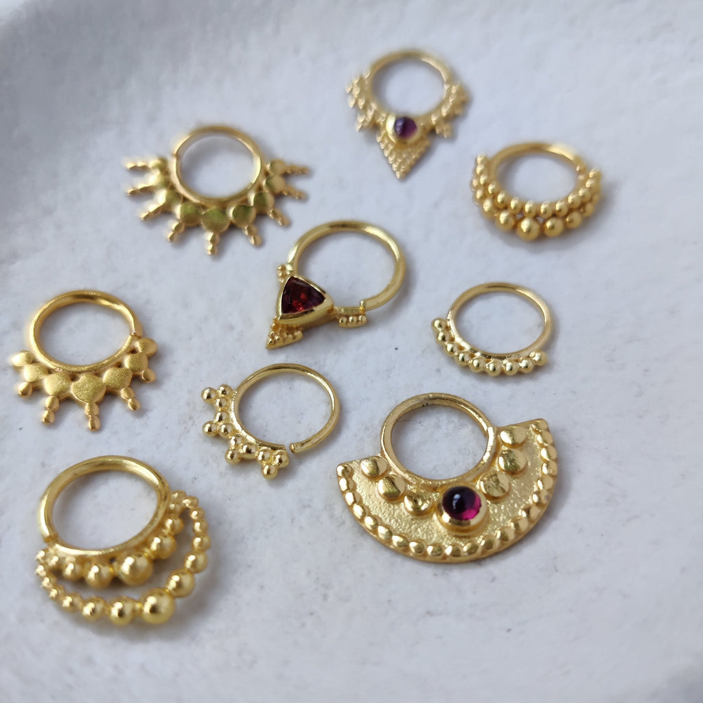 flatlay with septum jewelry gold and garnet