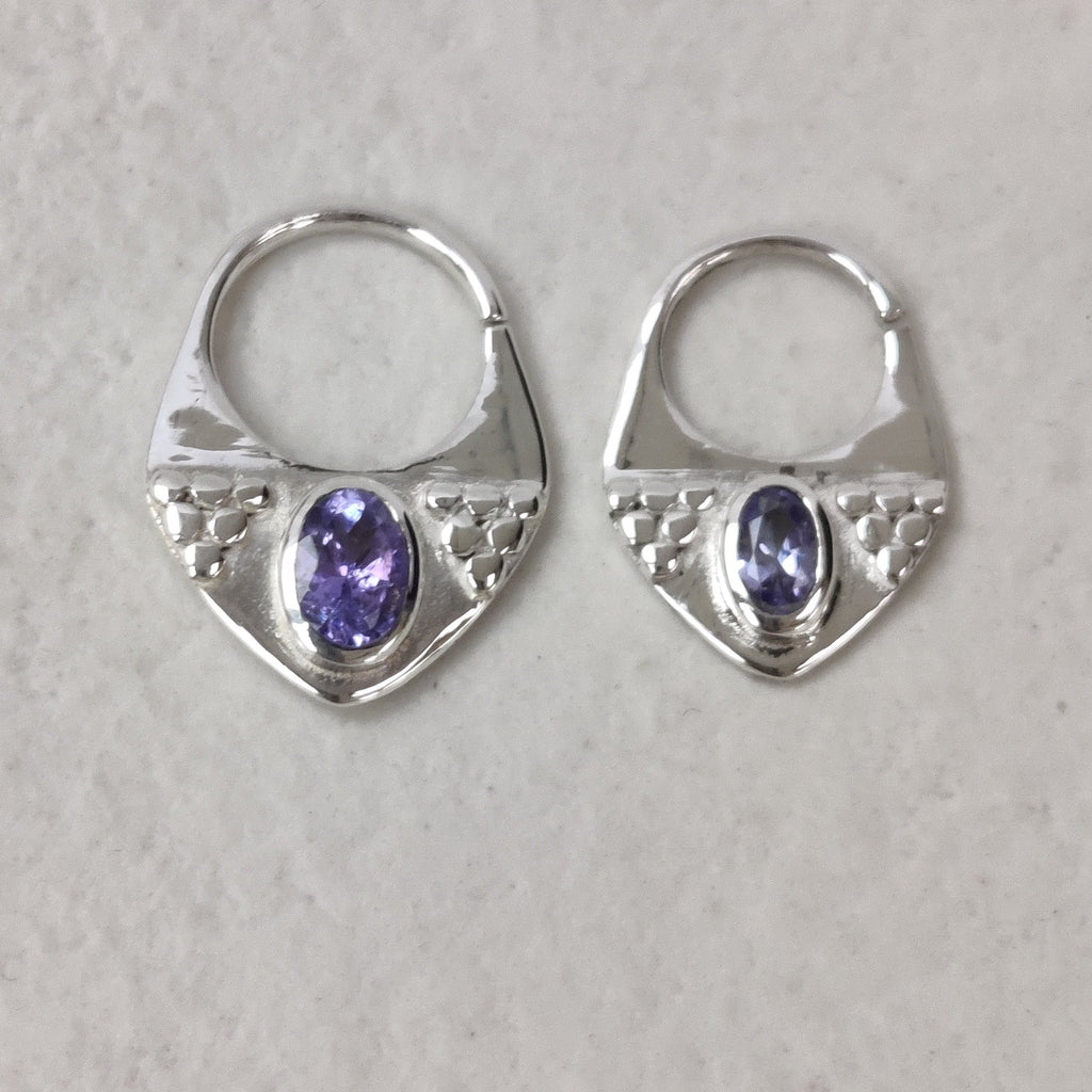 Two silver septum rings displayed side by side, to compare size difference between 8 mm and 10 mm