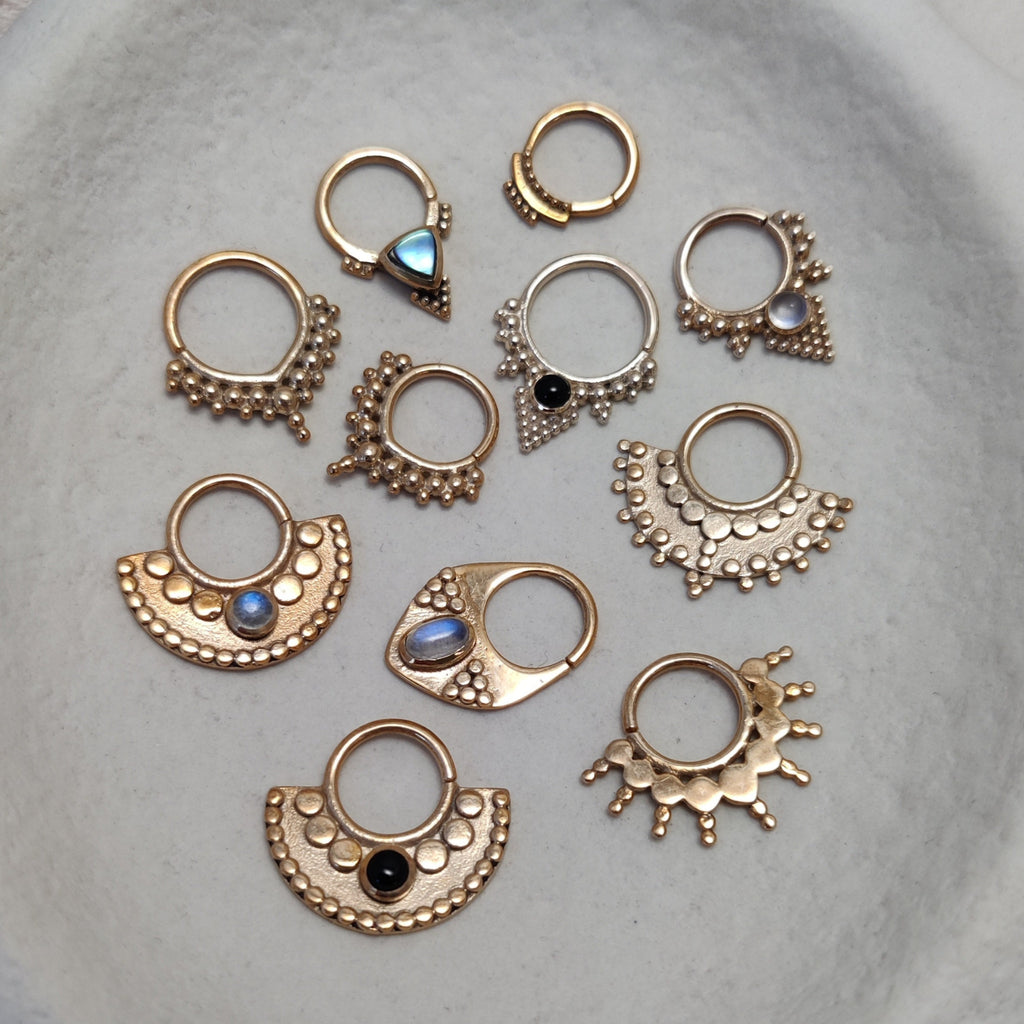 9k solid gold septum nose rings, displayed on a jewelry plate.