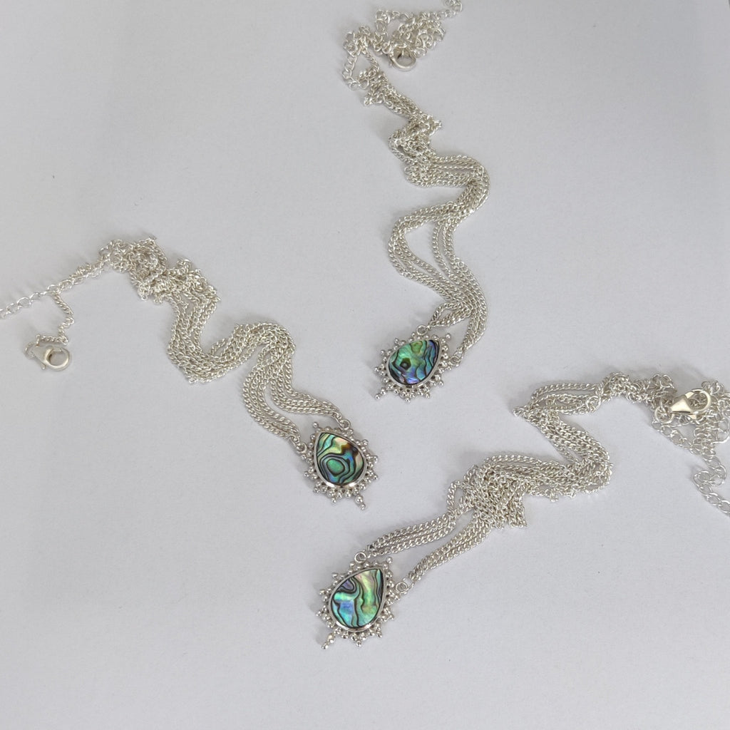 three head chains with abalone shell centerpieces, set in sterling silver