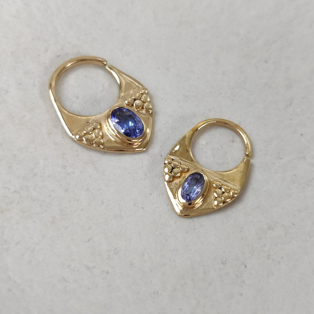 Triangle shaped gold septum nose rings with tanzanite gemstones
