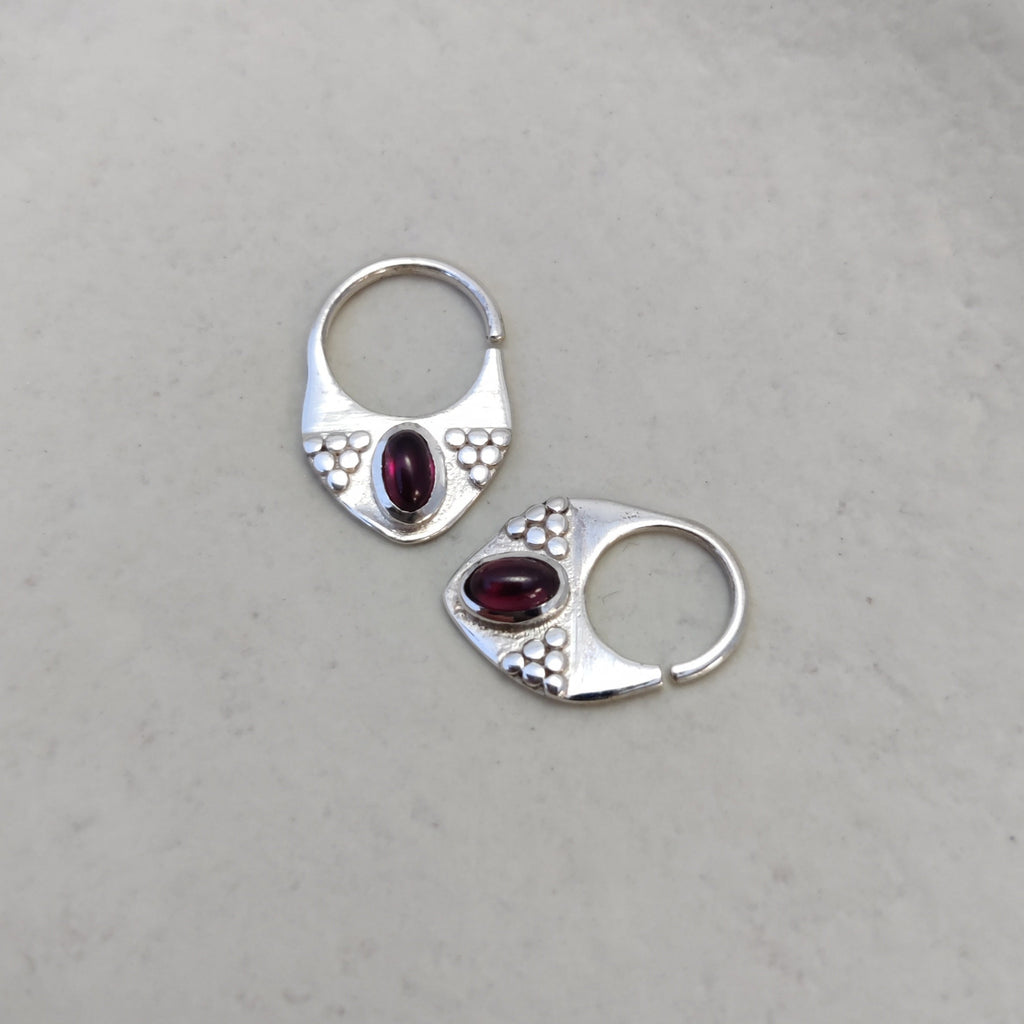 Silver septum jewelry with garnet, displayed side by side, comparing the difference between 8mm and 10mm diameters.