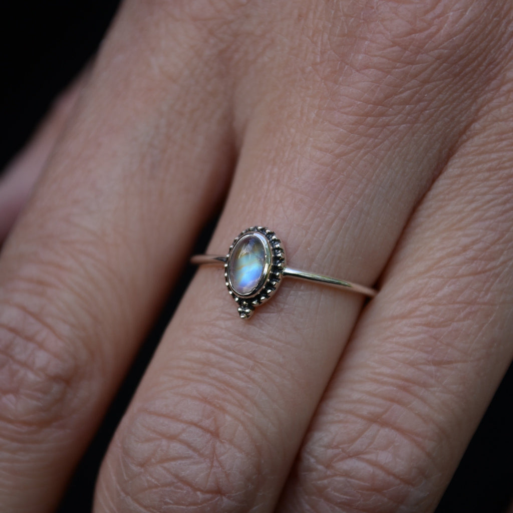 Close-up of a dainty moonstone silver ring