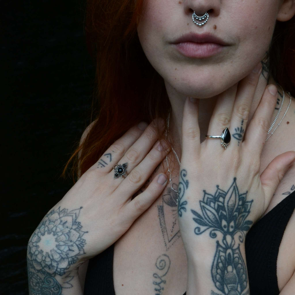 A model showcasing a layered look with a silver septum ring.